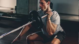 A man performing landmine squat