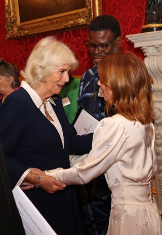 Camilla, Duchess of Cornwall meets Femi Elufowoju Jr and Geri Horner at a reception for winners of The Queen's Commonwealth Essay competition 2021