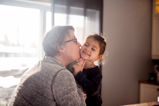 Grandmother with grandchild in childcare bubble