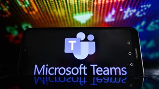 Microsoft Teams logo is displayed on a smartphone screen.