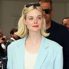 Elle Fanning wearing a blue Bottega Veneta suit at the airport in Nice, France May 2024