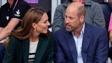 Catherine, Princess of Wales and Prince William, Prince of Wales look at each other as they watch the track cycling during the Glasgow 2026 Commonwealth Games
