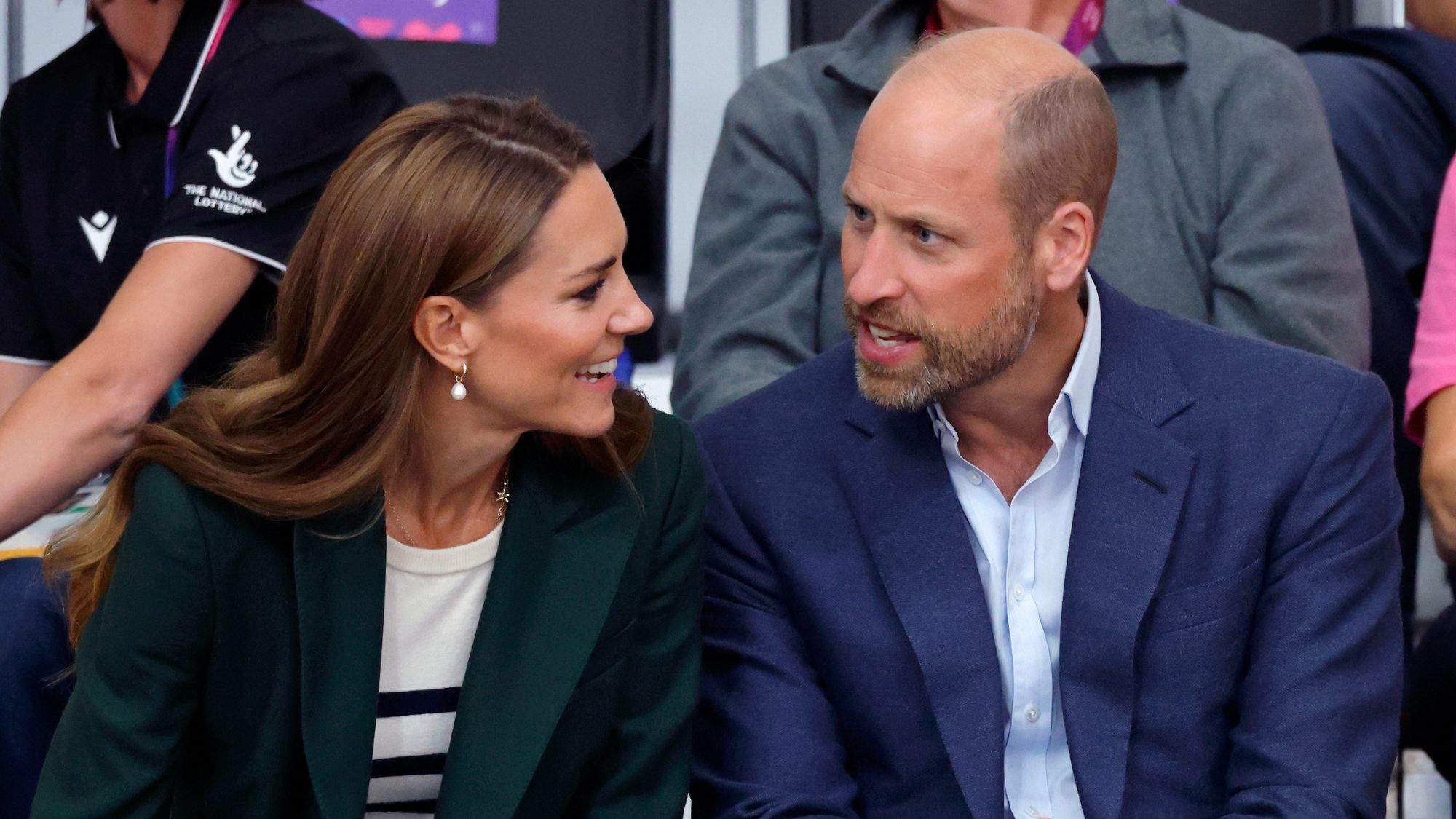 Catherine, Princess of Wales and Prince William, Prince of Wales look at each other as they watch the track cycling during the Glasgow 2026 Commonwealth Games