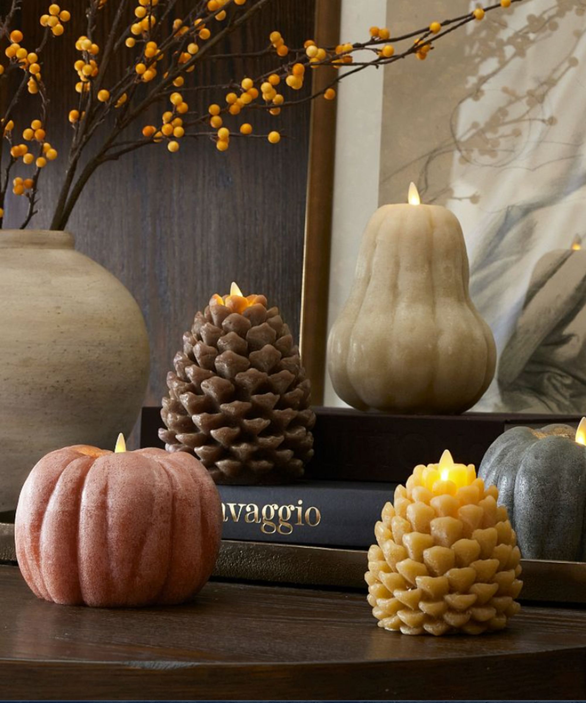 pumpkin and fir cone shaped candles in neutral fall colors