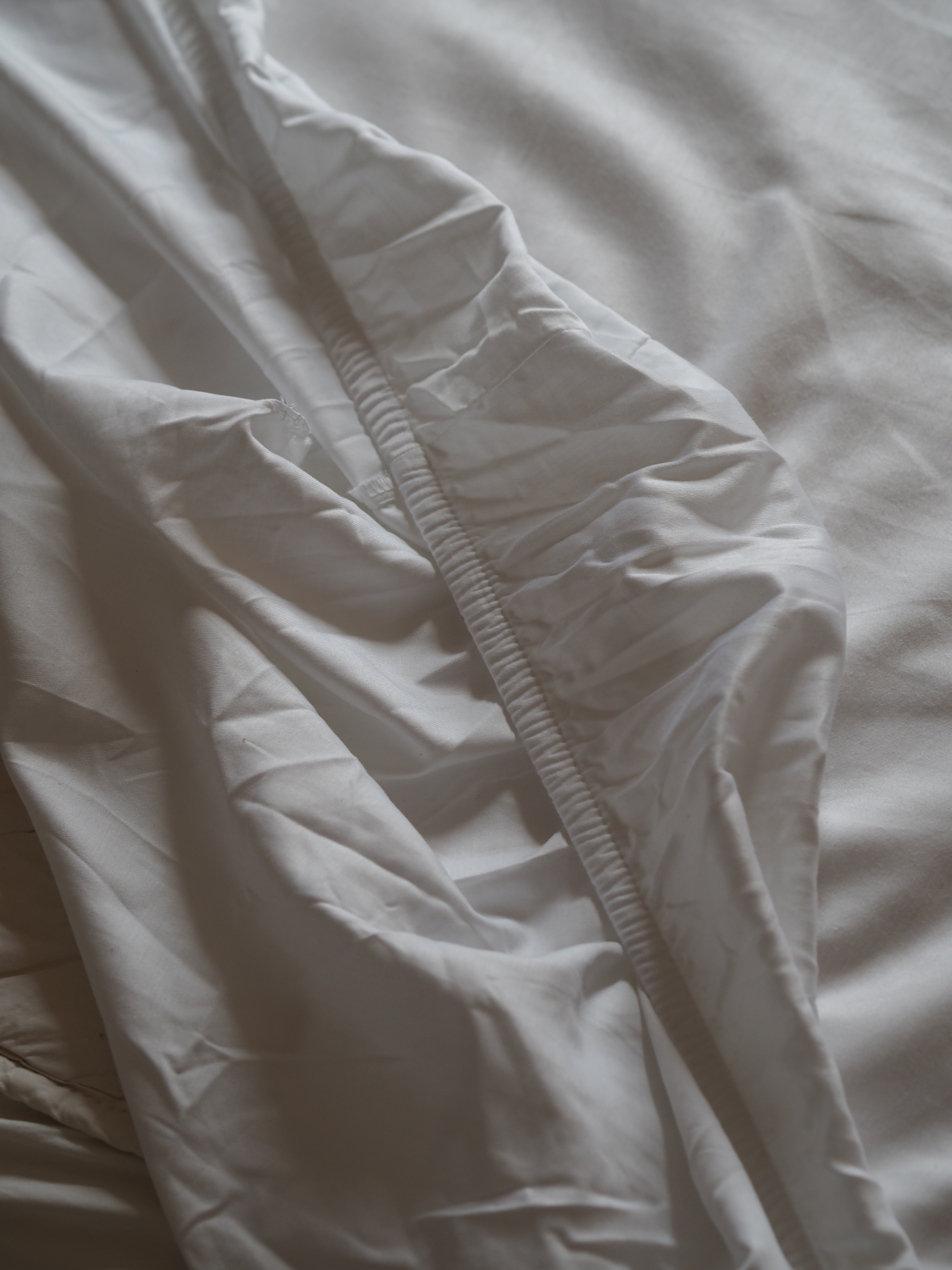 a plain white bed sheet