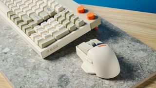 The Lofree Block keyboard on a stone surface with a blue wall in the background.