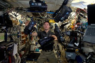 French astronaut Thomas Pesquet juggles camcorders aboard the International Space Station in this photo he tweeted on Dec. 27, 2016.