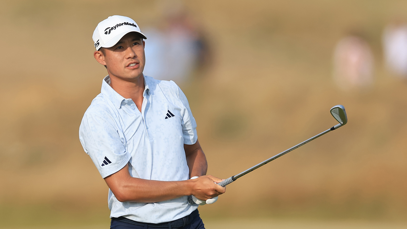 Collin Morikawa watches an iron shot