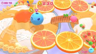 Kirby's Dream Buffet: Blue Kirby rolling around arena with orange slices.