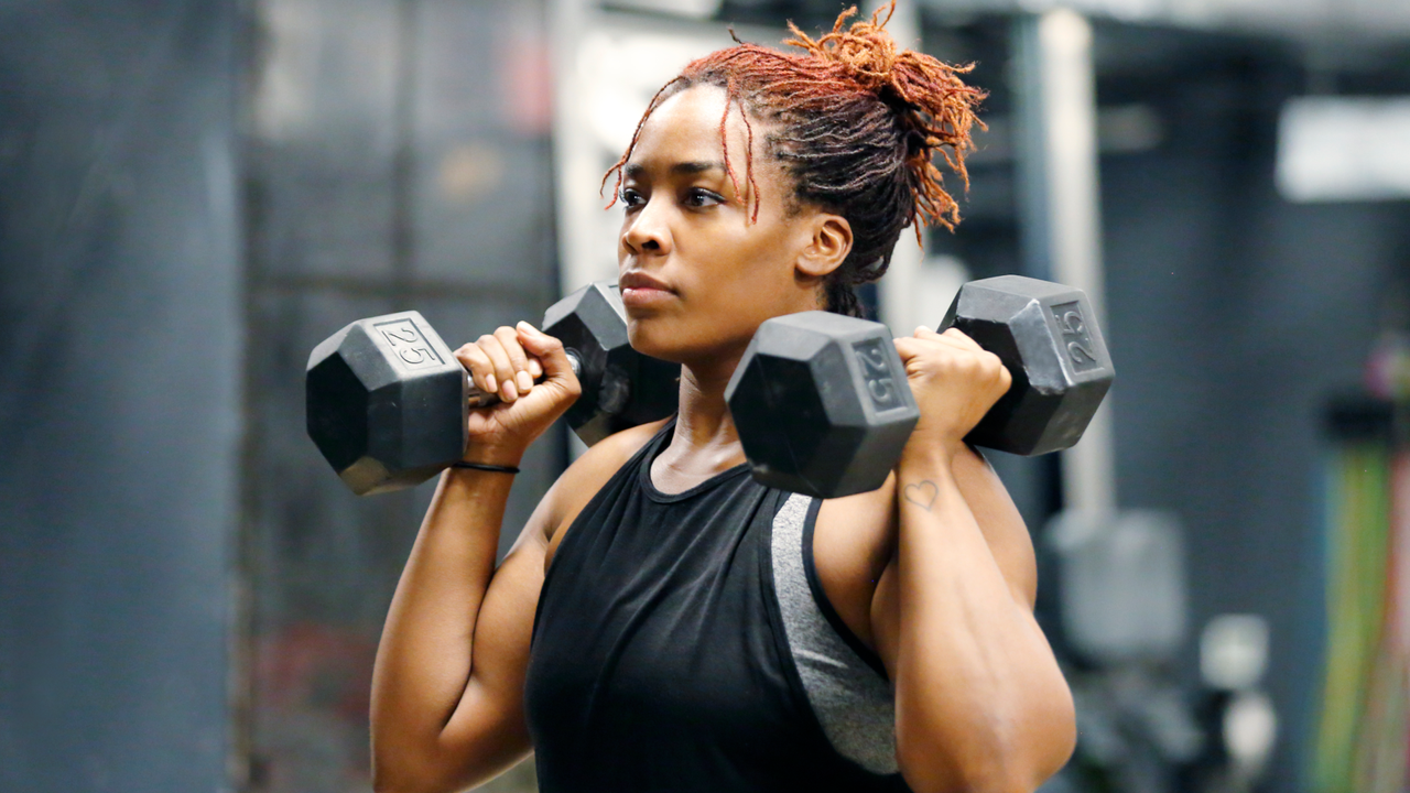 Woman doing dumbbell shoulder press