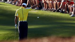 Tiger Woods takes a penalty drop at the 15th during the 2013 Masters