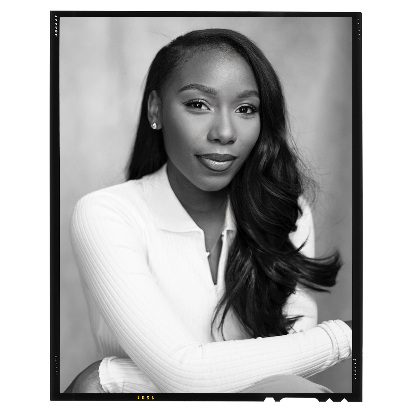 black and white portrait of Ah-Niyah Gold in a white v-neck polo sweater