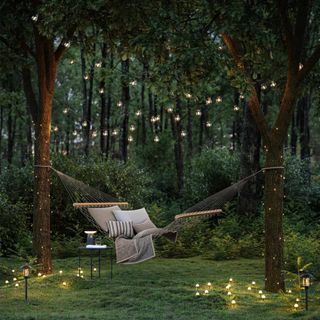 garden area with solar lighting and hammock with tree lights