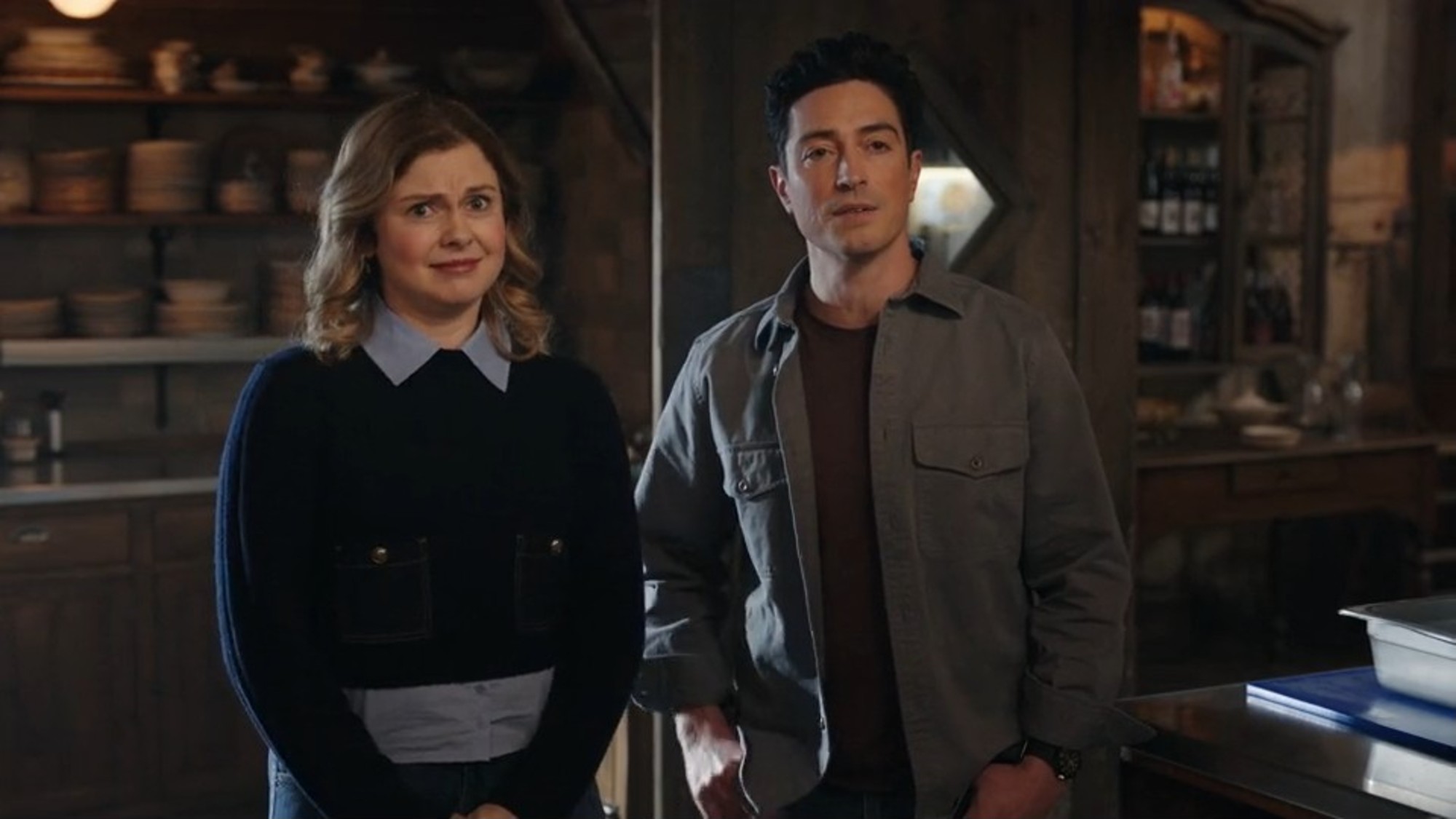 Rose McIver and Ben Feldman standing next to each other awkwardly in Ghosts.
