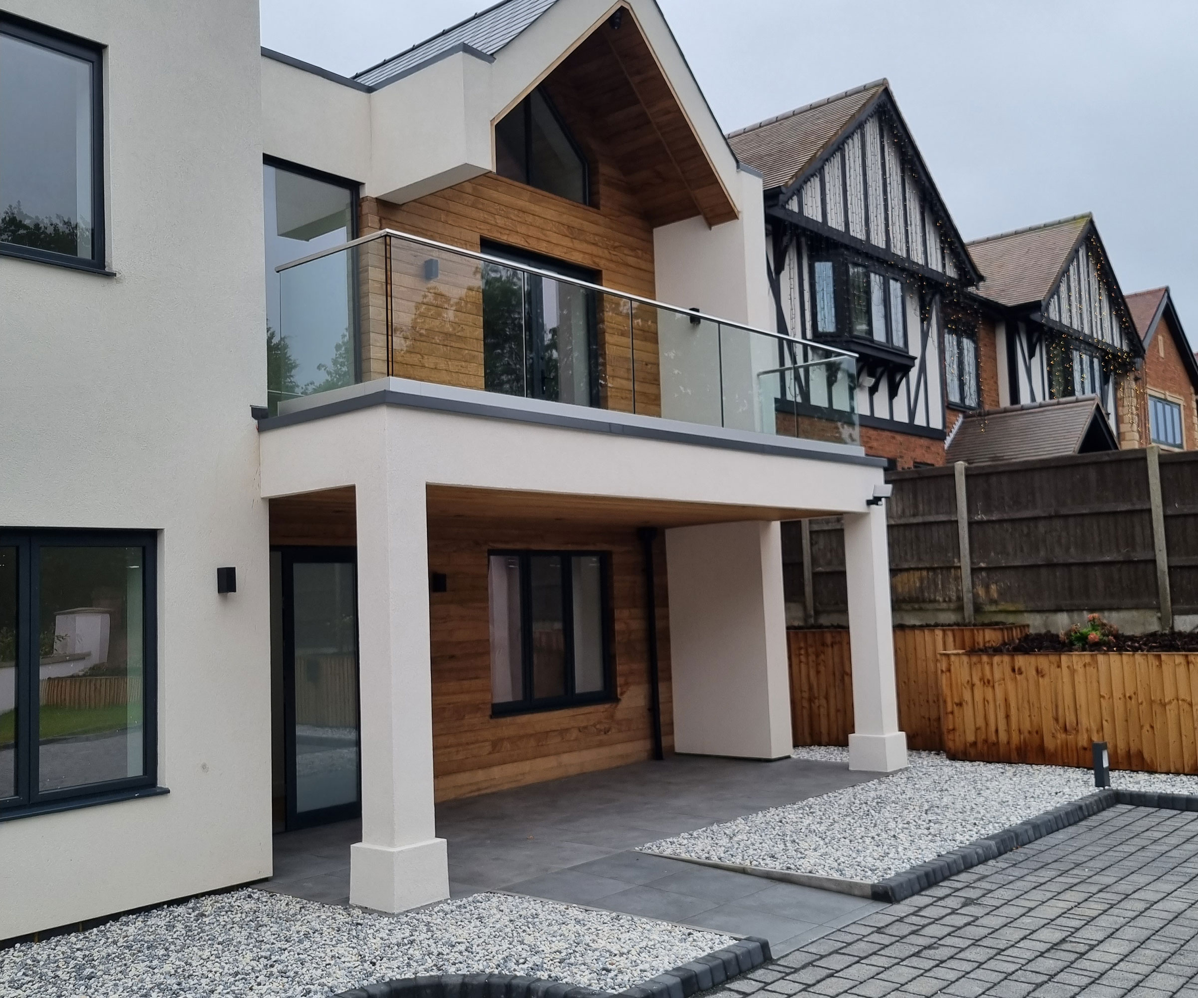 modern house with flat roof porch with balcony above