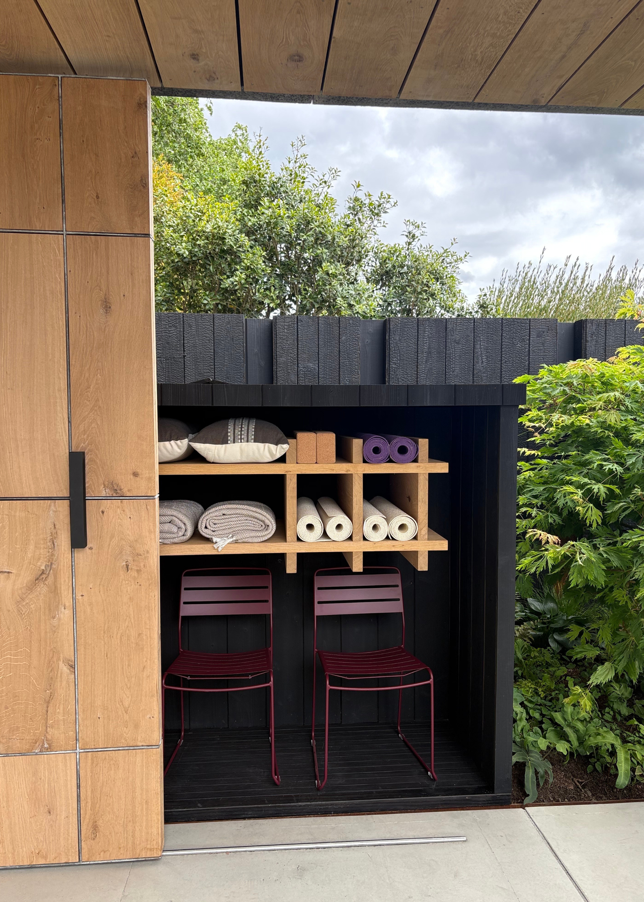 An outdoor wellness corner with yoga mats and pillows at the Chelsea Flower Show 2026