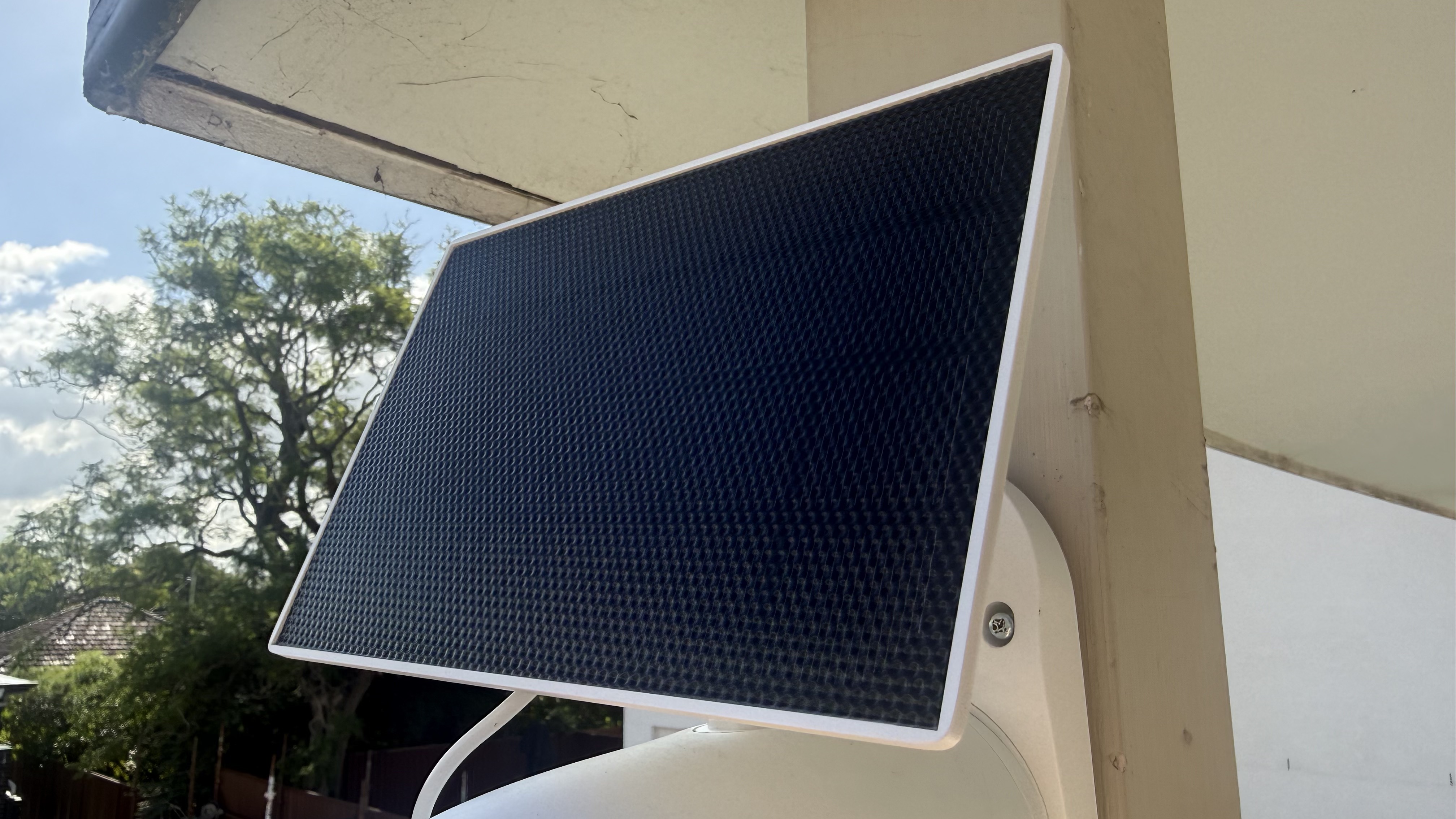 The Tapo C660 Kit solar panel mounted with the camera on a wooden pole