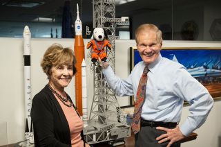 NASA Administrator Bill Nelson (right) holding the Artemis I Snoopy zero-gravity indicator, is seen with Jeannie Schulz, widow of Peanuts gang creator Charles M. Schulz, Wednesday, April 5, 2023, during a visit to the Mary W. Jackson NASA Headquarters building in Washington.