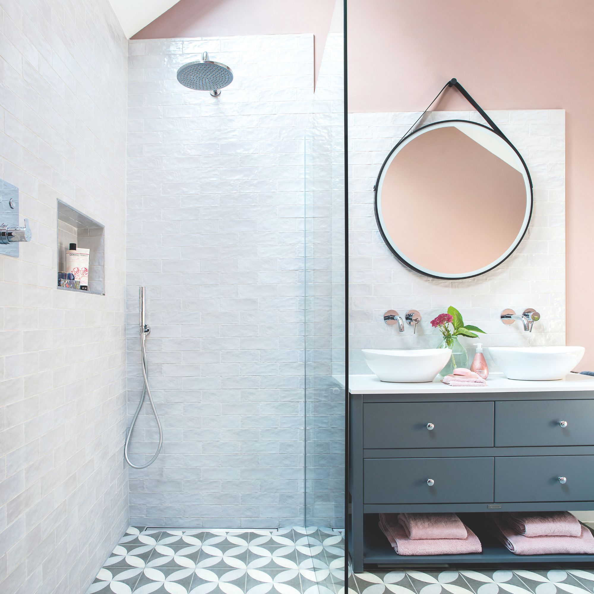 Pink painted bathroom with white tiled shower area