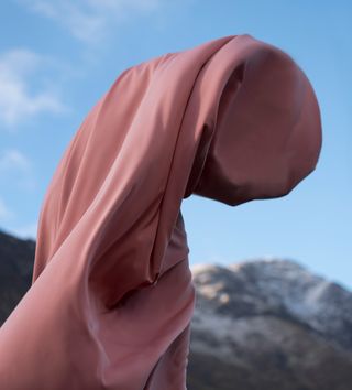 A person wrapped in pink fabric.