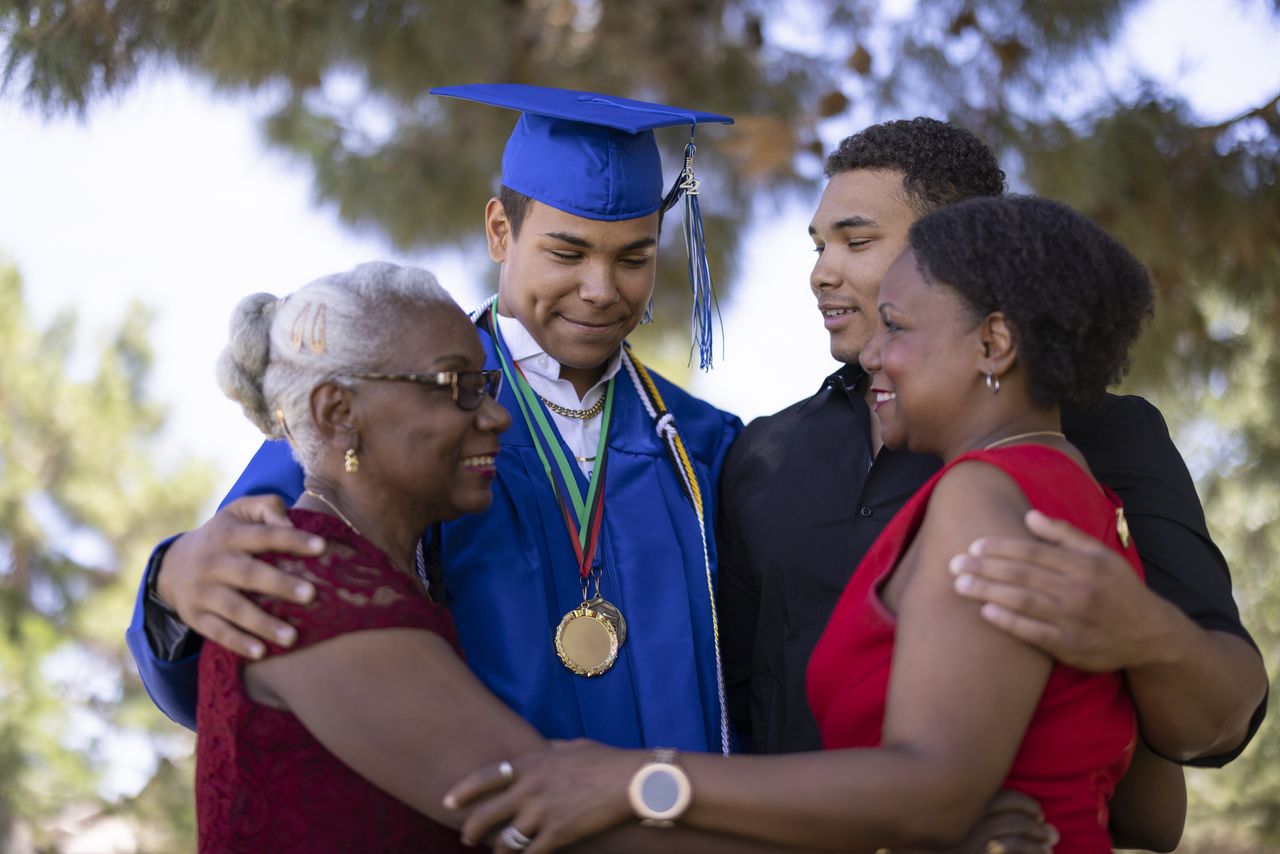 Three generations of a family celebrate a young man&#039;s graduation from college.