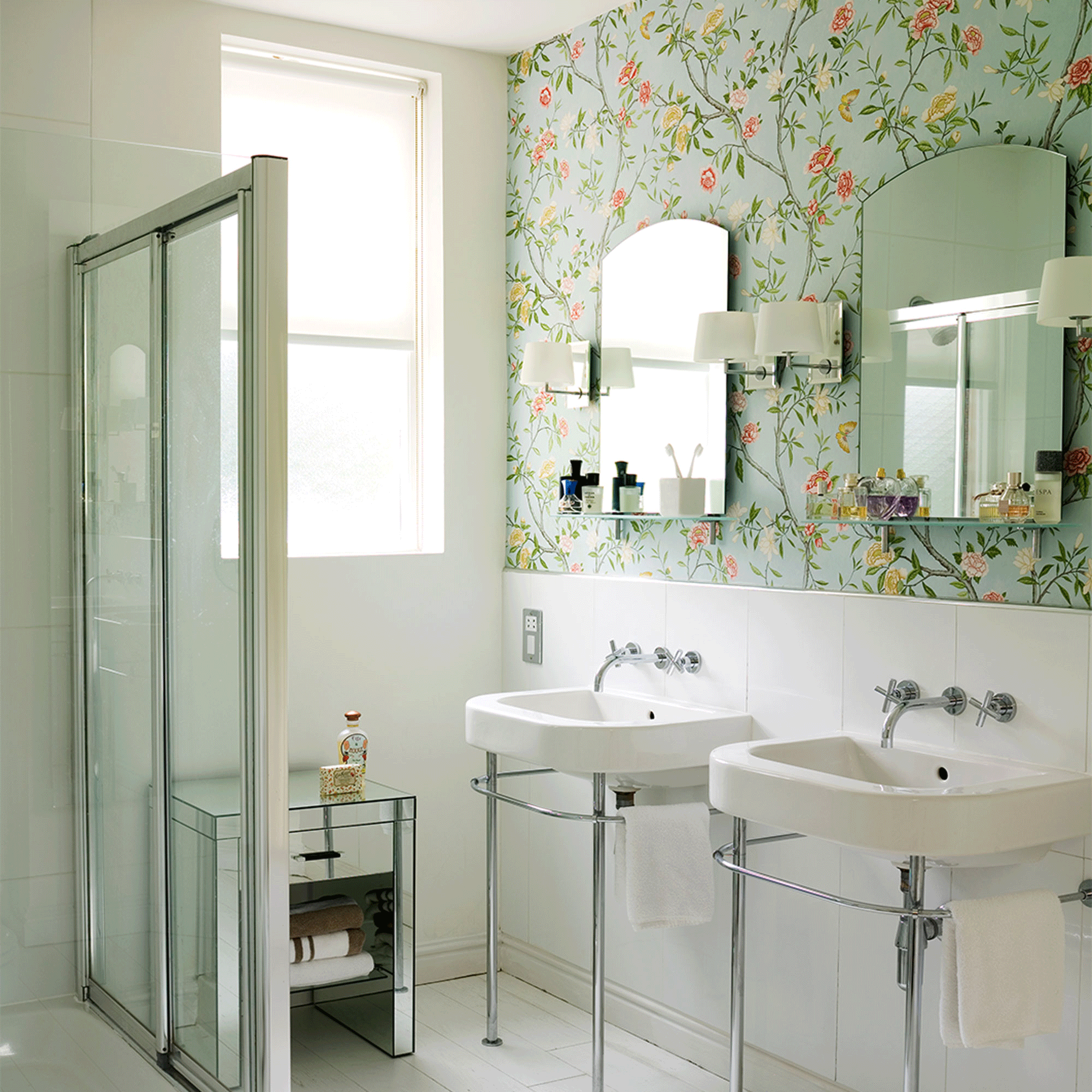 wallpapered bathroom with glass door