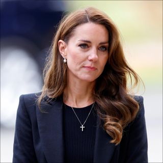 Kate Middleton looks sad while wearing all black, she has long wavy brunette hair