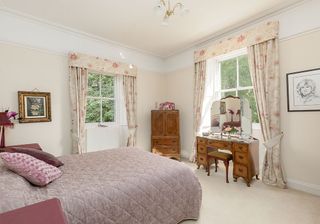 bedroom with white wall and white windows with curtains
