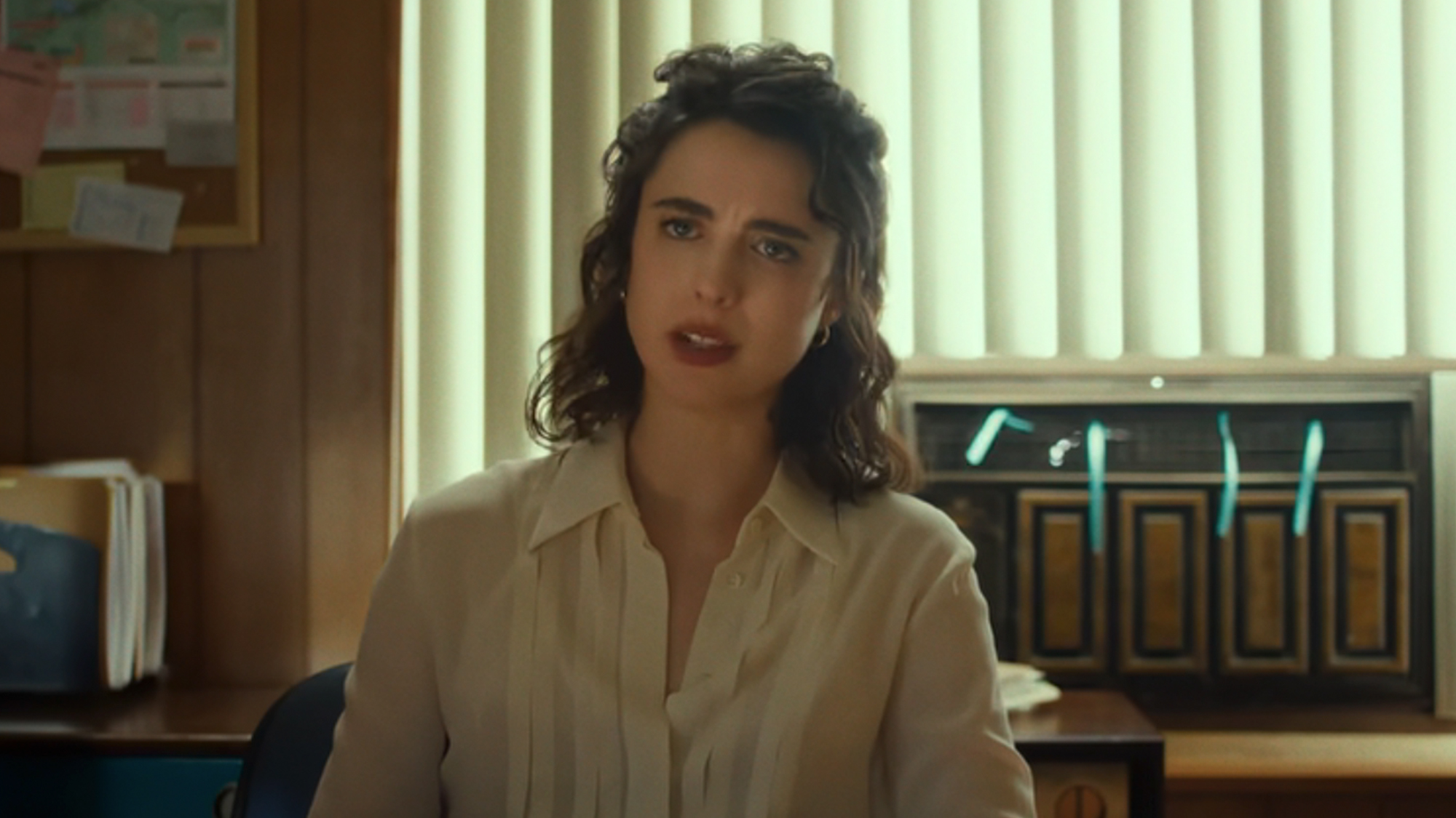 Margaret Qualley in a white shirt, looking frustrated in Honey Don'te