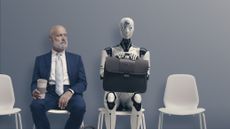 A man looking suspiciously at a robot at they both wait for a job interview.