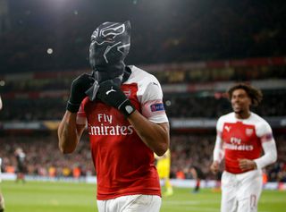 Pierre-Emerick Aubameyang of Arsenal celebrates by wearing a mask of Marvel superhero Black Panther, after scoring against Rennes in the Europa League last 16 at the Emirates Stadium in London, March 2019.
