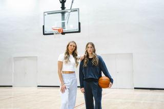 Lexie Hull and Kate Martin on an indoor basketball court wearing Athleta for the brand's latest Power of She Collective announcement shoot.