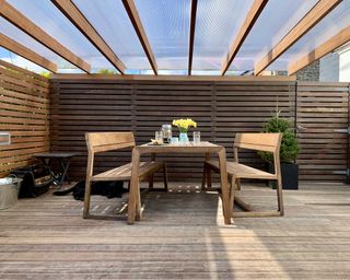 deck by gripsure covered by pergola with clear plastic sheets