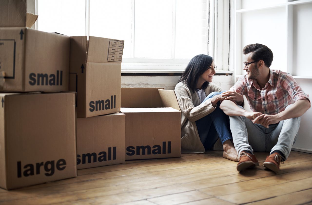 Couple relaxing after moving into new cozy loft apartment