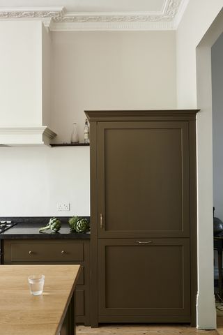 extra large fridge in a brown cabinet in a modern kitchen