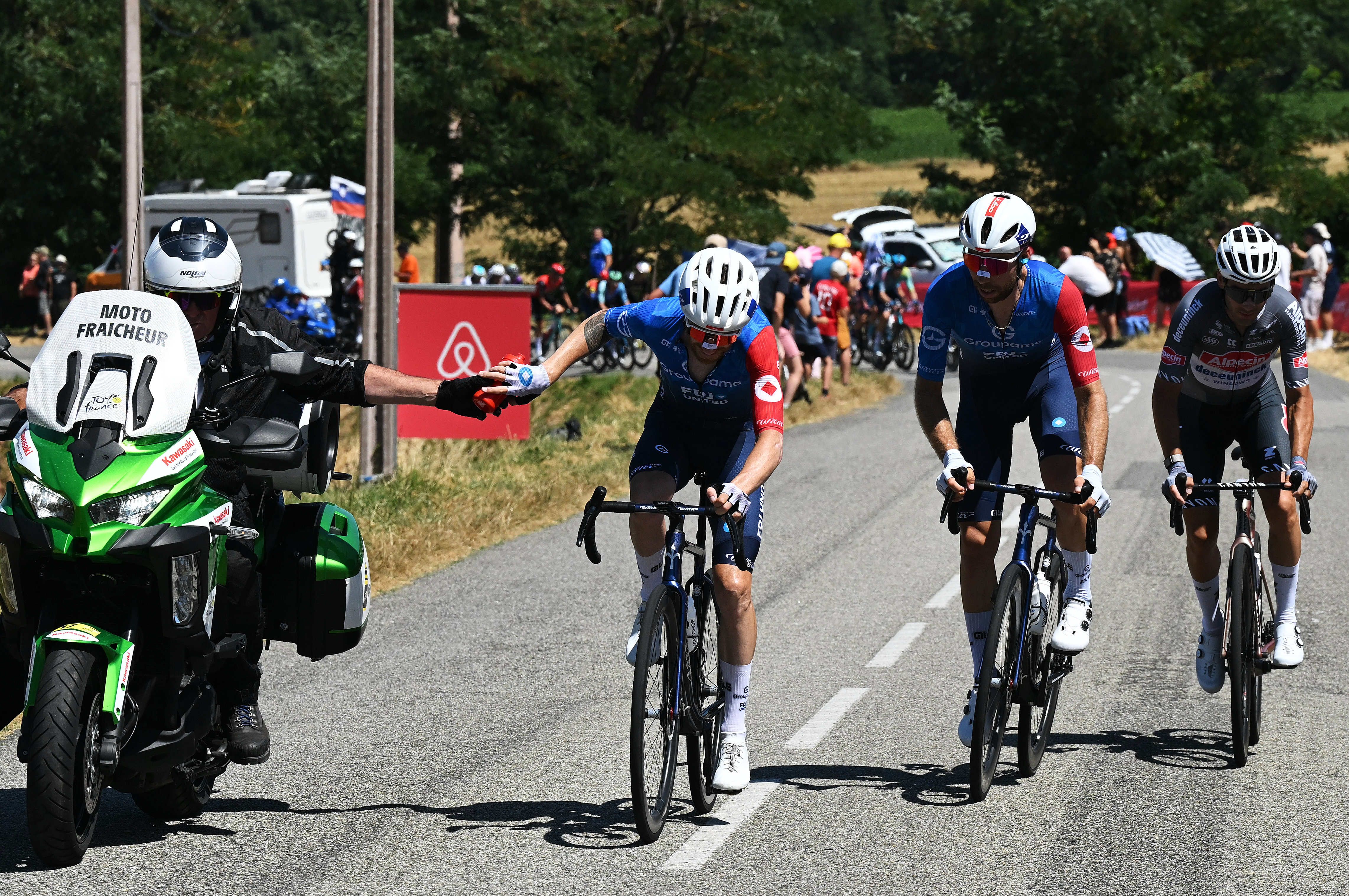 TOULOUSE, FRANCE - JULY 16: (L-R) Quentin Pacher of France (picking bottles from a motorbike assistant), Clement Russo of France and Team Groupama - FDJ and Gianni Vermeersch of Belgium and Team Alpecin - Deceuninck compete in the chase group during the 112th Tour de France 2025, Stage 11 a 156.8km stage from Toulouse to Toulouse / #UCIWT / on July 16, 2025 in Toulouse, France. (Photo by Tim de Waele/Getty Images)