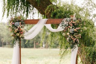 backyard wedding ideas arch decorated with flowers