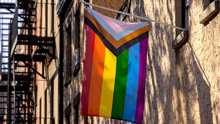 LGBTQI flag hanging on a building in Greenwich Village, New York City, USA - stock photo