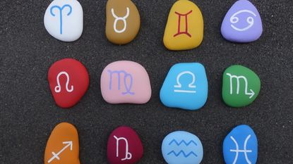 zodiac signs painted on stones