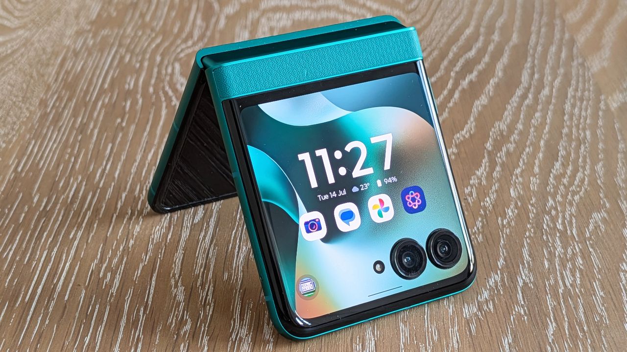 Motorola Razr 2026 in blue, being held in the hand