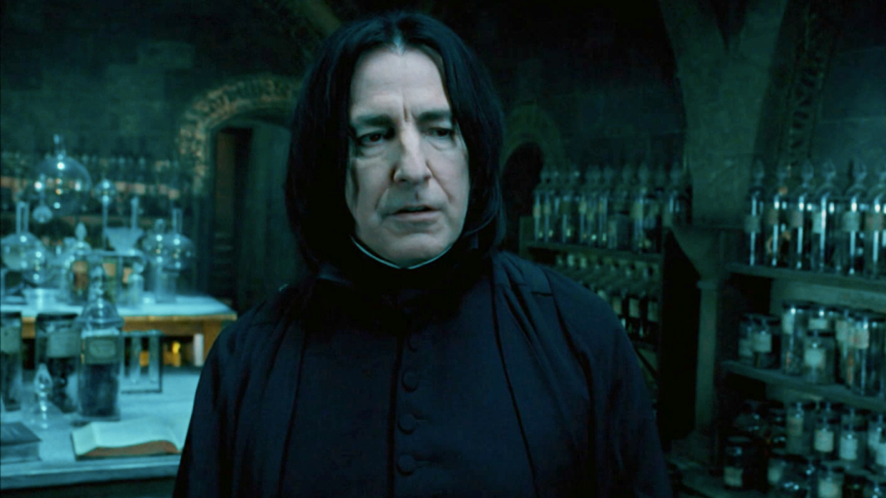 Alan Rickman stands frustrated, amid a variety of potion bottles, in Harry Potter and the Order of the Phoenix.