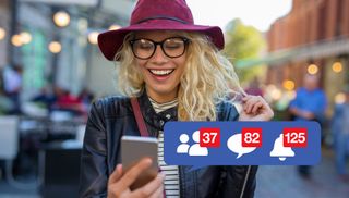 Smiling blonde woman wearing glasses and a floppy hat looking at her phone with Facebook notification icons superimposed on the image.