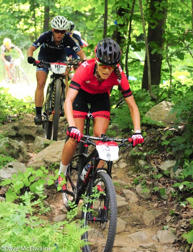 Kate Courtney (Specialized) leading Chloe Woodruff through a rock garden