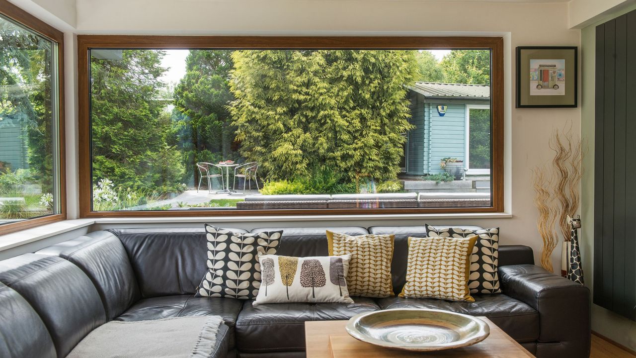 Dual aspect picture windows in seating area, with wood-effect internal frames and views of the garden