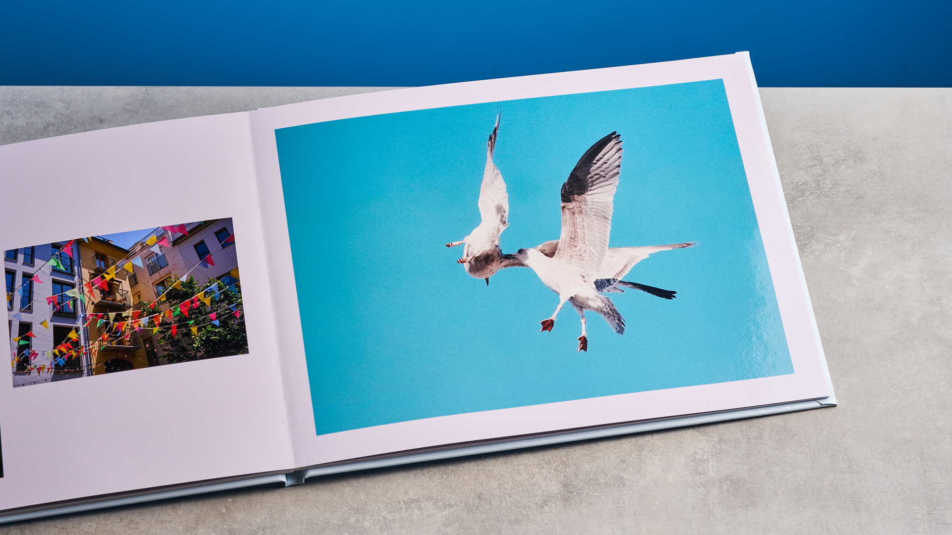 Popsa photo book photographed in front of a blue background