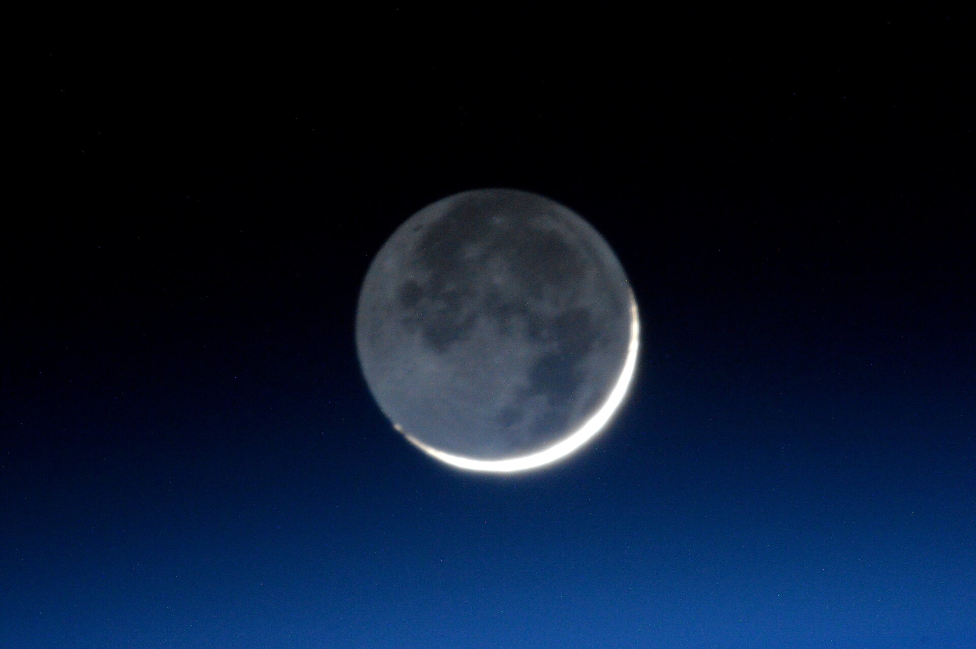 waxing gibbous moon is illuminates from Earthshine.