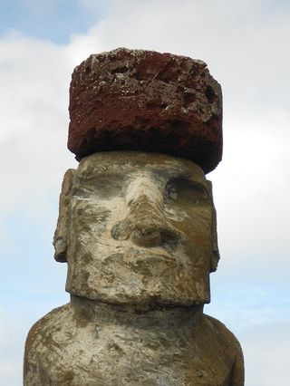 A red pukao was restored atop a moai located on the south coast of Rapa Nui.