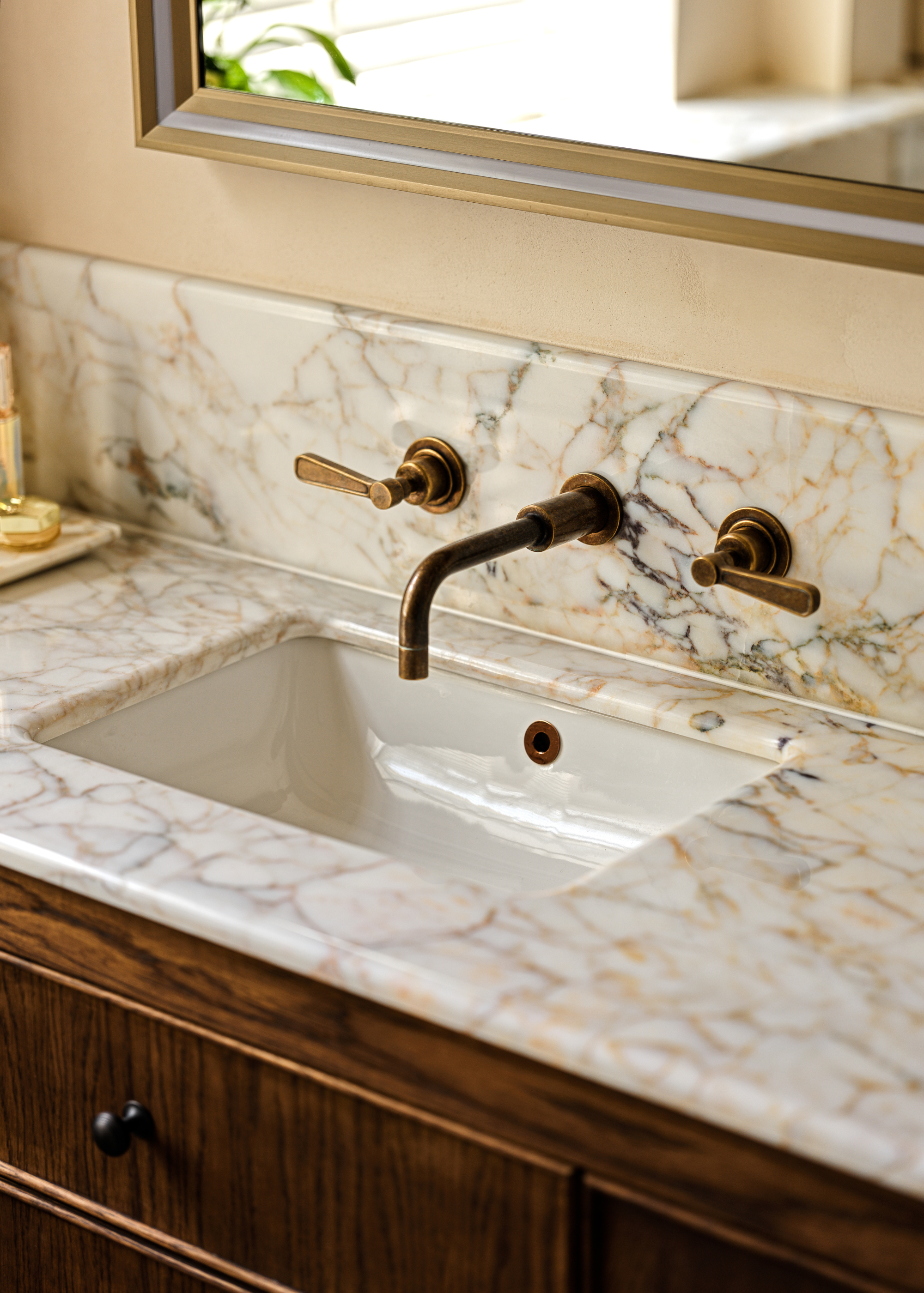 ottoman marble countertop in a bathroom with wooden cabinetry