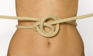 A woman's abdomen shown with a knotted rope in front