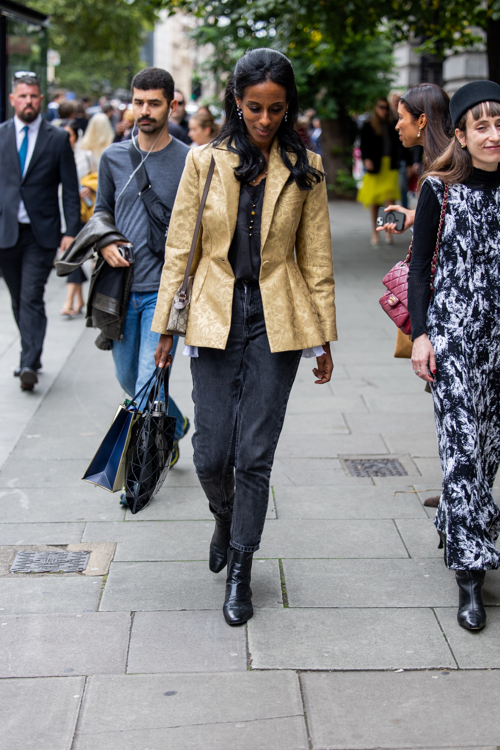 woman wearing brocade jacket and jeans